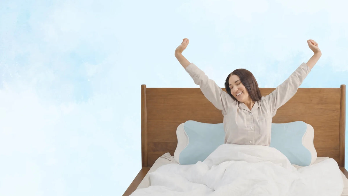 Woman waking up refreshed and well-rested after sleeping on Sleepsake pillows
