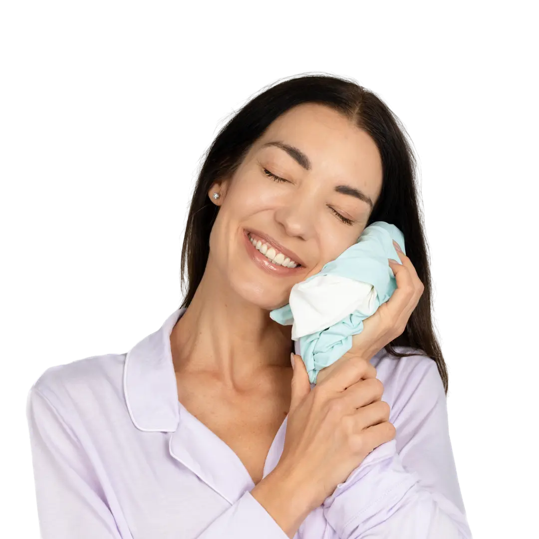 Woman holding Sleepsake cover against her face, showing how soft it is.